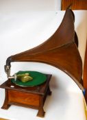An oak table top wind-up gramophone: with wooden sound horn.