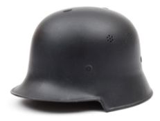 A WWII German M40 helmet:, black with brown leather lining stamped '55',