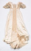 An Edwardian cream silk and lace wedding or evening dress:,
