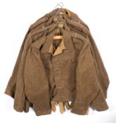 A group of seven WWII 1940 battle dress tunics,