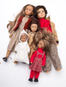 A group of five French Bella Cathie dolls:, two adults, two children and a baby,