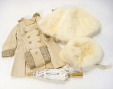 An early 20th century child's cream silk coat: together with matching white muff and white fur cap,