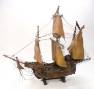 A scale model of the Santa Maria:, fully rigged over a single block hull, 57cm high.