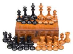 A boxwood and ebony Staunton pattern chess set:, unsigned, in a mahogany box, height of white King,