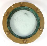 A circular brass porthole with glass:, 38cm diameter. *Provenance.