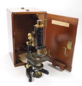 A black lacquer 'Service' microscope by Watson & Sons, London:, coarse and fine adjust,