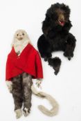 An early 20th century Continental clockwork black fur bear:, with glass eyes,