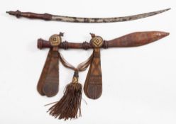 An early 20th century West African Mandigo sword:, the curved blade with single fuller,