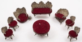 An eight piece doll's house salon suite made from pins:, comprising a chaise longue, four chairs,