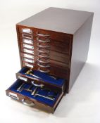 A collection of Victorian and later toffee hammers in a collectors cabinet:,