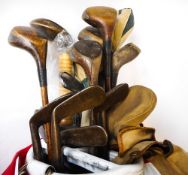 A golf club bag containing hickory shafted golf clubs: including mashie niblicks, jigger,