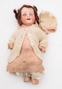 A German bisque headed doll by Heubach Kopplesdorf:, brown wig, brown glass sleeping eyes,