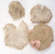 A collection of early 20th century lace and textiles:, including a group of silk and lace bonnets,