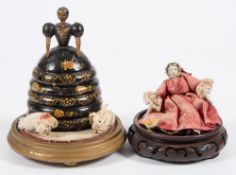 A late 19th century wooden lacquer doll, box and cover:, with painted face and gilt decorated dress,