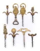 A group of eight brass direct pull corkscrews:, including one with Lincolnshire Imp handle (8).