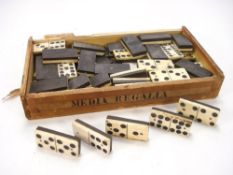 A late 19th/early 20th century set of bone and ebony dominoes:, in an associated cigar box.