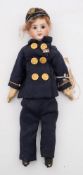 An early 20th century French bisque head doll:, red wig, fixed brown glass eyes,