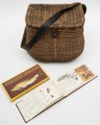 An early 20th century wicker creel/fishing seat:, with brown leather shoulder strap,