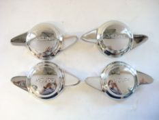 A set of four Jaguar two-eared wire wheel spinners:,