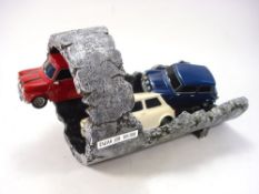 A limited edition 'Italian Job ' model of three BMC Mini Coopers in a drainpipe:, number 109/500,