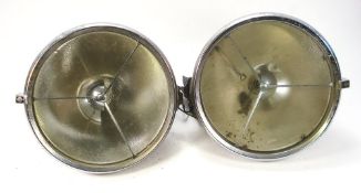 A pair of Lucas P100L headlamps:, triple bar pattern with stippled lens,