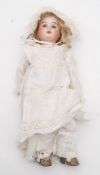 An Armand Marseille bisque head doll:, blonde wig, blue glass paperweight eyes,