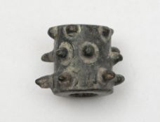 An Antiquarian bronze mace head, circa 300BC:, of cylindrical form with cast barbs, 2.2cm long.