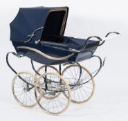 A Wilson Silver Cross Pram:, with blue canvas hood, spoked wheels with white rubber treads..