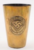 A Third Reich period Reichsarbiestdienst brass cup:, with raised Female Youth Camp emblem to body,