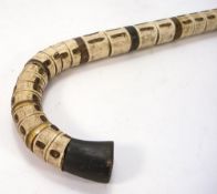 An early 20th century shark vertebrae walking stick:, 91cm.