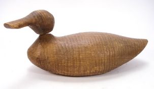 An early 20th century carved wooden duck decoy:,