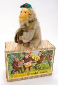 A West German clockwork musical monkey in original box:.