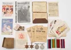 A group of four WWII service medals:, together with an army pay book ,