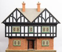 A mid-20th century mock Tudor style doll's house together with a collection of later furniture