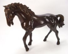 A 20th century bronze model of a stallion: unsigned, 58cm. long..