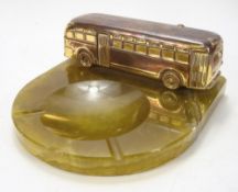 A mid-20th century gilt copper and onyx ashtray with a model of a coach:, 21cm wide.