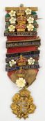 A Victorian/Edwardian Primrose League badge with eight Special Service bars 1886 to 1906:.