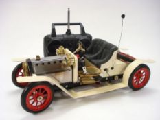 A Mamod live steam car: fitted for radio control together with some Meccano.