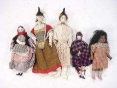 A group of five late 19th /early 20th century costume dolls:, porcelain and cloth head examples,