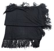 A Victorian black silk shawl,: the central panel of geometric leaf pattern with a tassel fringe,