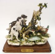 A Capo di Monte porcelain hunting scene,: of pheasants and gun dogs around a tree stump.