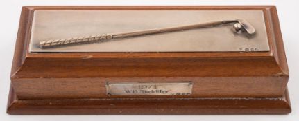 A Garrard & Co silver golf trophy in the form of a putter and ball, on a wooden plinth,