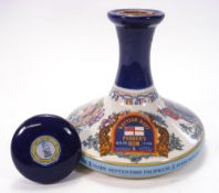 A sealed bottle of British Navy Pusser's Rum in a Wade porcelain Nelson commemorative ship's