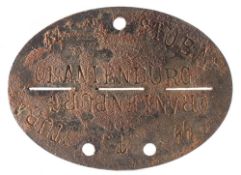 A German grey metal dog tag, stamped '4806' and ' SS T Stuba Oraienburg':.