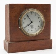 A Smiths dashboard clock:, with arabic numerals, numbered 39772 in a later mahogany mount, 15.