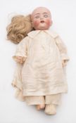 A German bisque head doll by Franz Schmidt:, blonde wig , blue glass sleeping eyes,