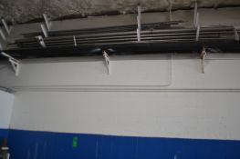 Lot of Approx. (8) Pieces of S/S Tubing (Some New) and Conveyor Rails on Rack on Wall Near Ceiling