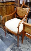 Window seat, the splayed ends decorated with roses and with cane sides and seat, 104cm wide,