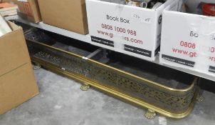 Brass fire curb with a foliate fretwork design,