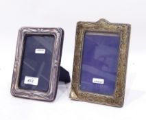 A silver mounted photograph frame, rectangular form with scroll decoration,